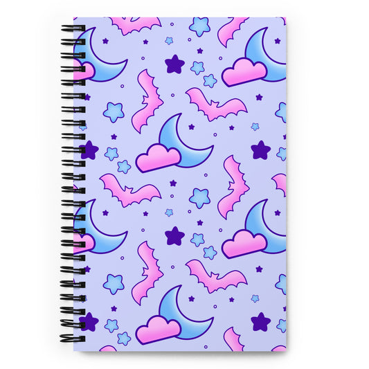 spiral bound, dot-grid, notebook with pink bats, pink clouds, blue moons, and stars